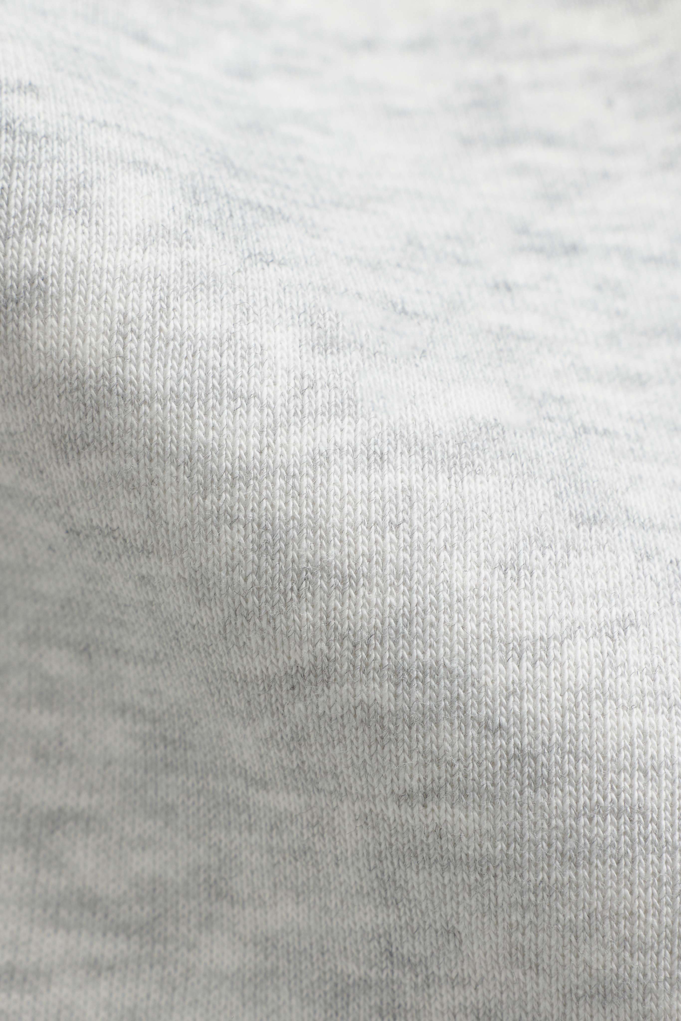 Close-up of the grey melange cotton-blend fabric on a CASPARA zip hoodie.
