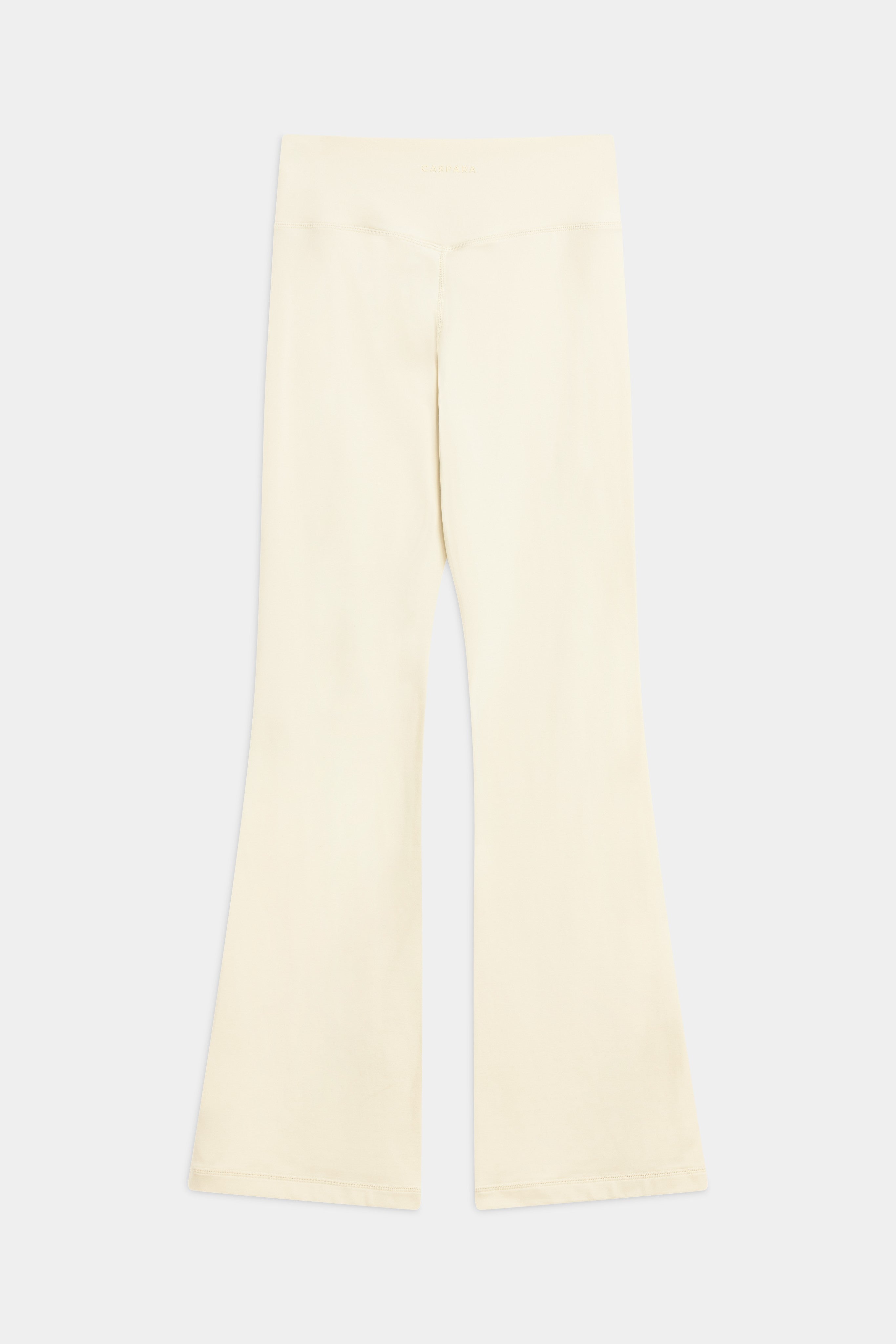 Back view of CASPARA Cloudform flared yoga pants in butter yellow against a light grey background.
