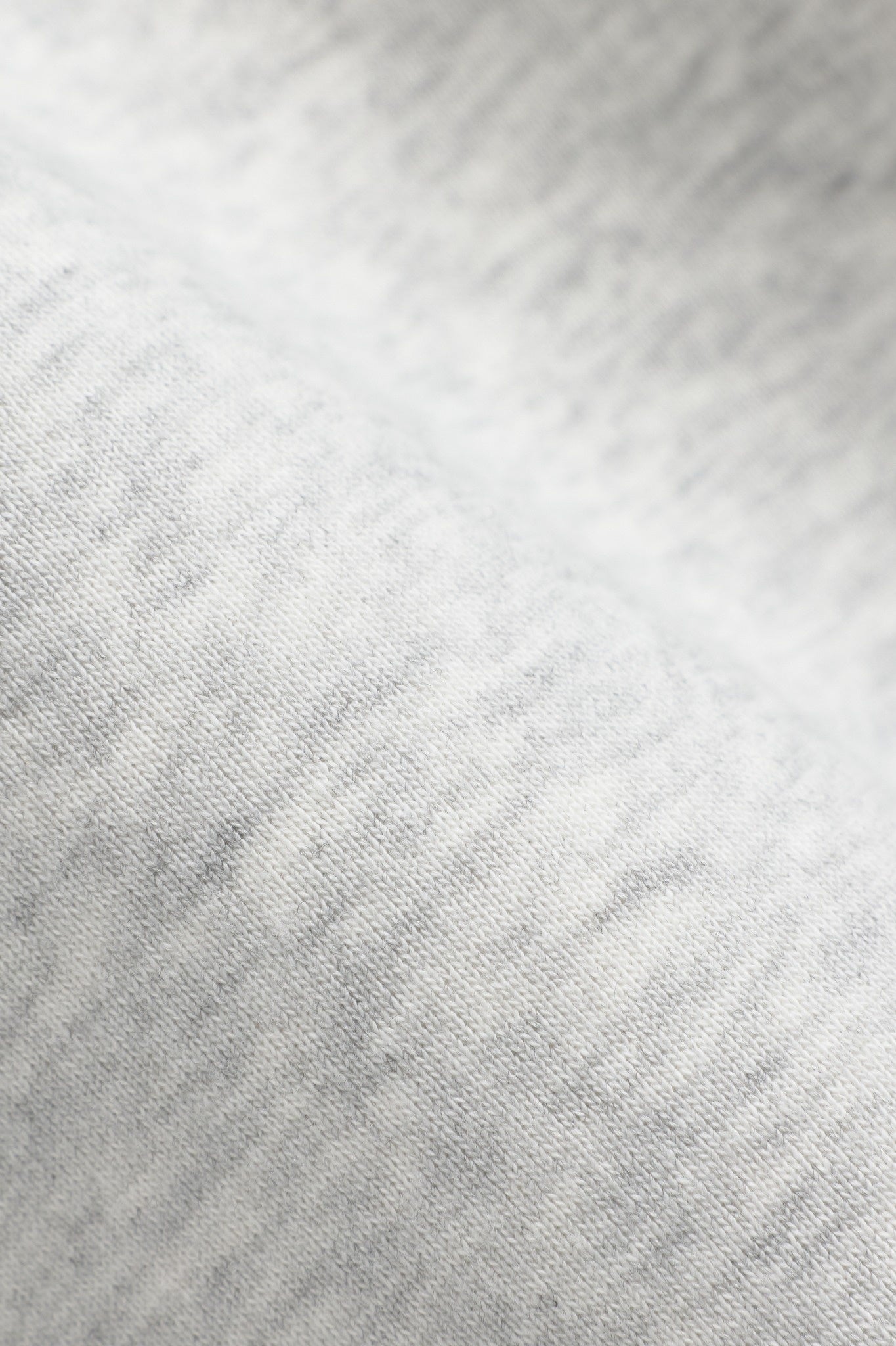 Close-up of the soft grey melange cotton fabric on a CASPARA 1/4 Zip sweatshirt.
