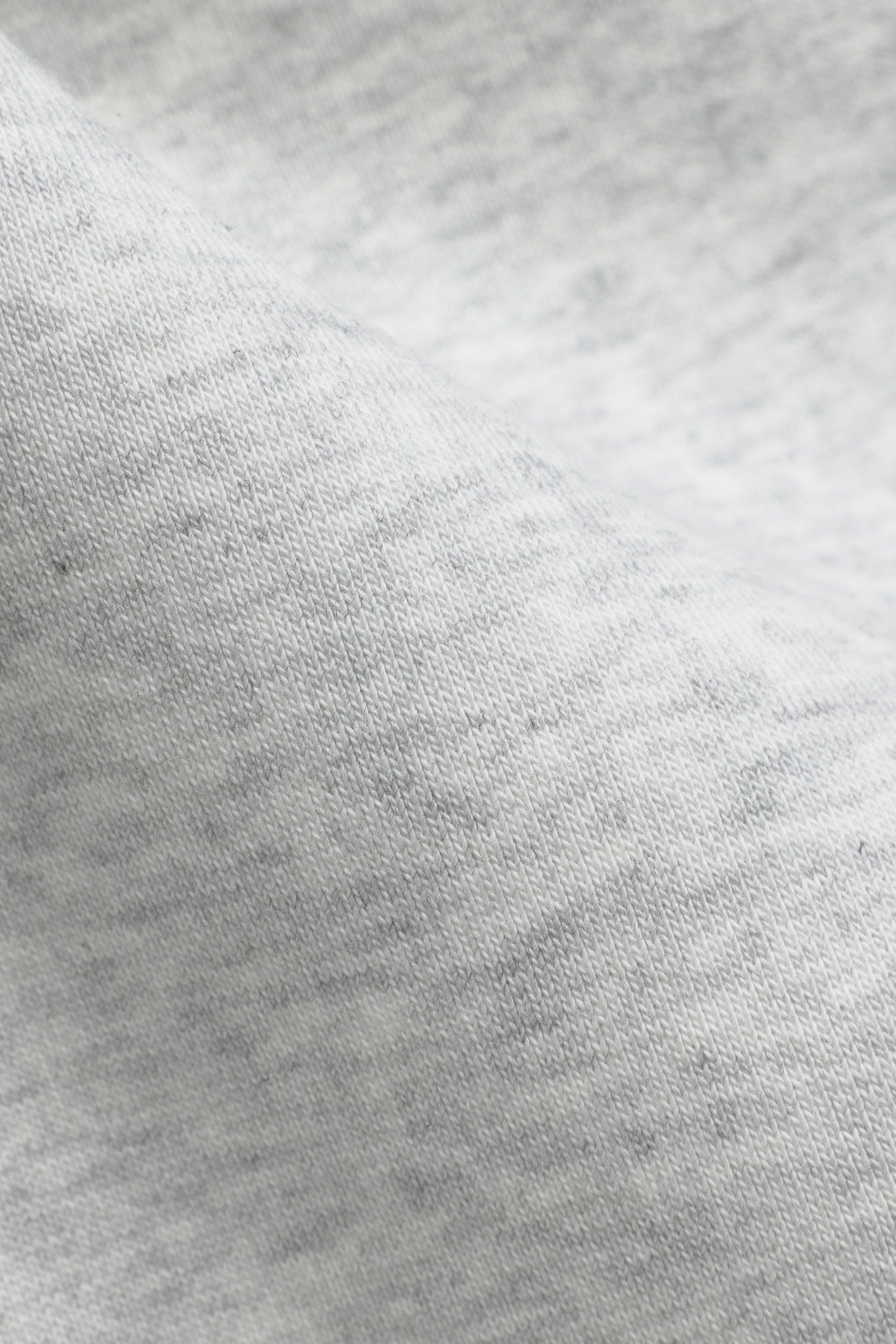 Close-up of grey melange cotton fabric texture on CASPARA All-Star SL pants.