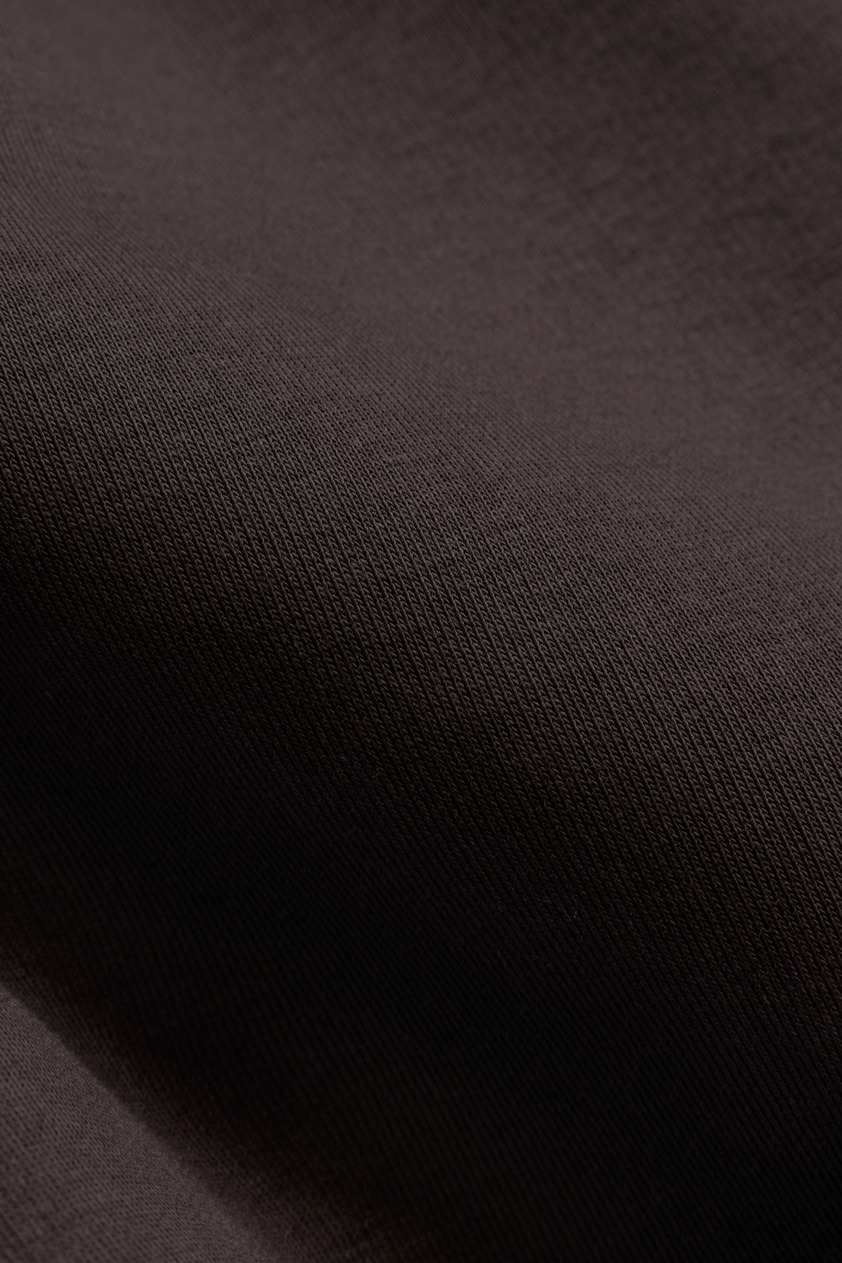 Close-up of the espresso brown heavyweight cotton fabric on the CASPARA All-Star hoodie.