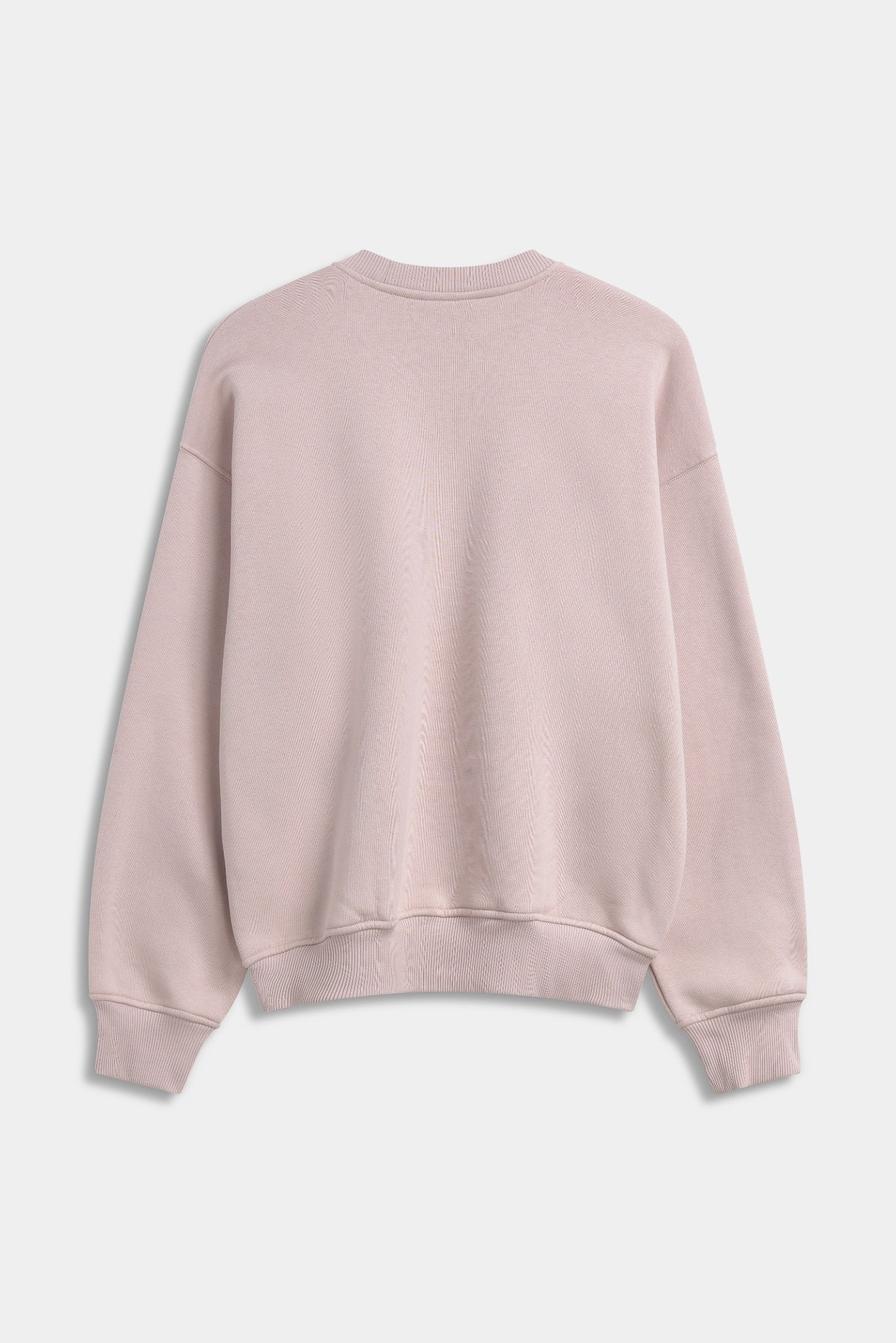 Back view of a dusty pink CASPARA oversized crewneck sweatshirt against a grey background.
