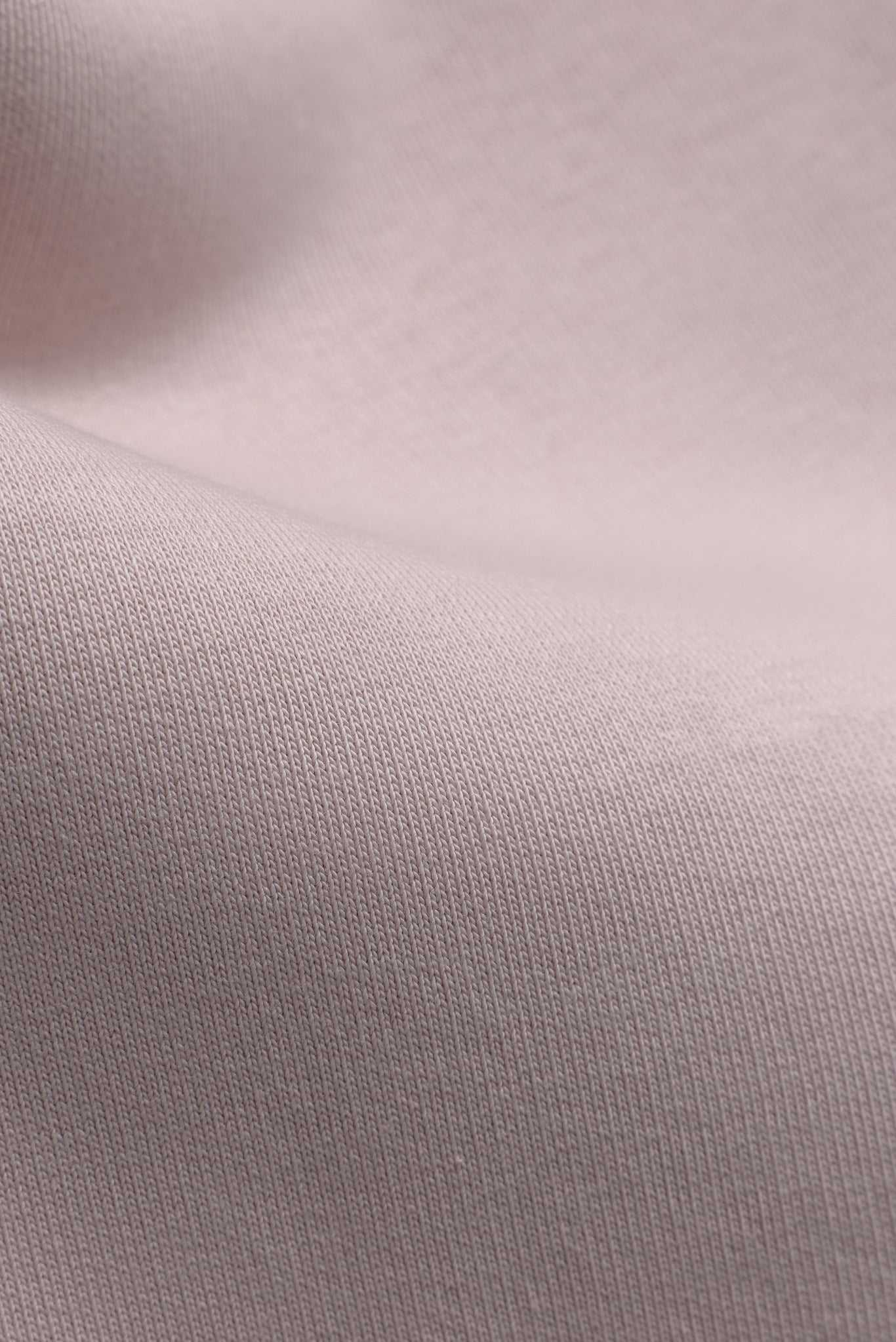 Close-up of dusty pink cotton fabric texture on CASPARA All-Star SL pants.