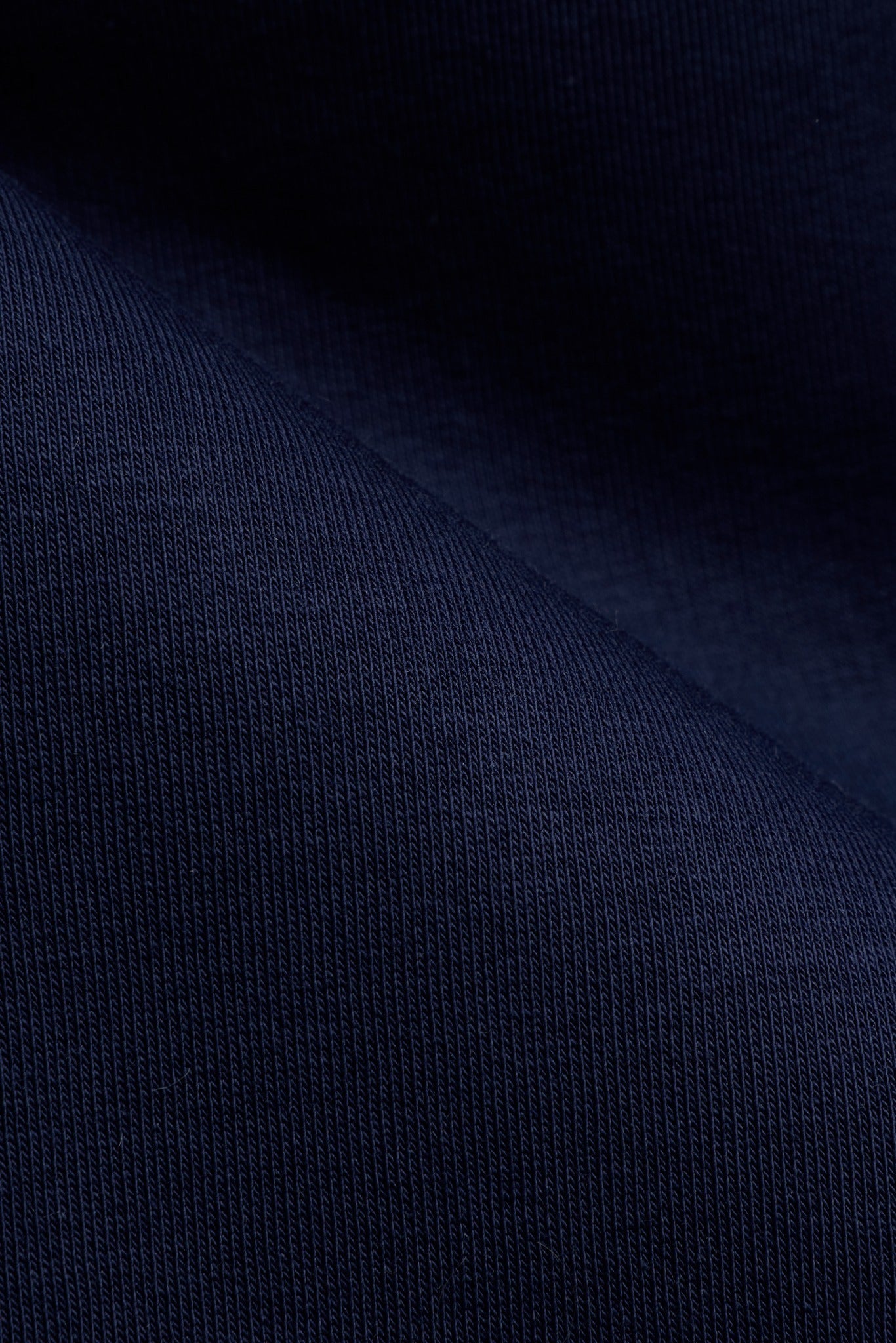 Close-up of navy blue textured cotton fabric on the CASPARA M. 1/4 Zip sweatshirt.