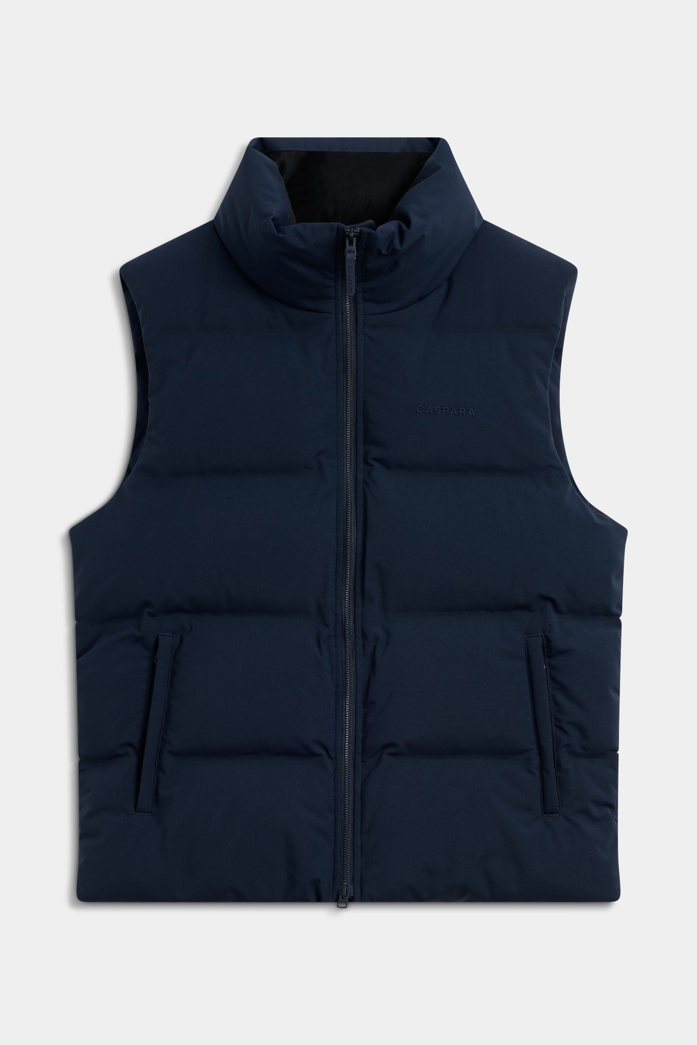 Navy blue CASPARA Boreal puffer vest with a high collar and front zip against a light grey background.