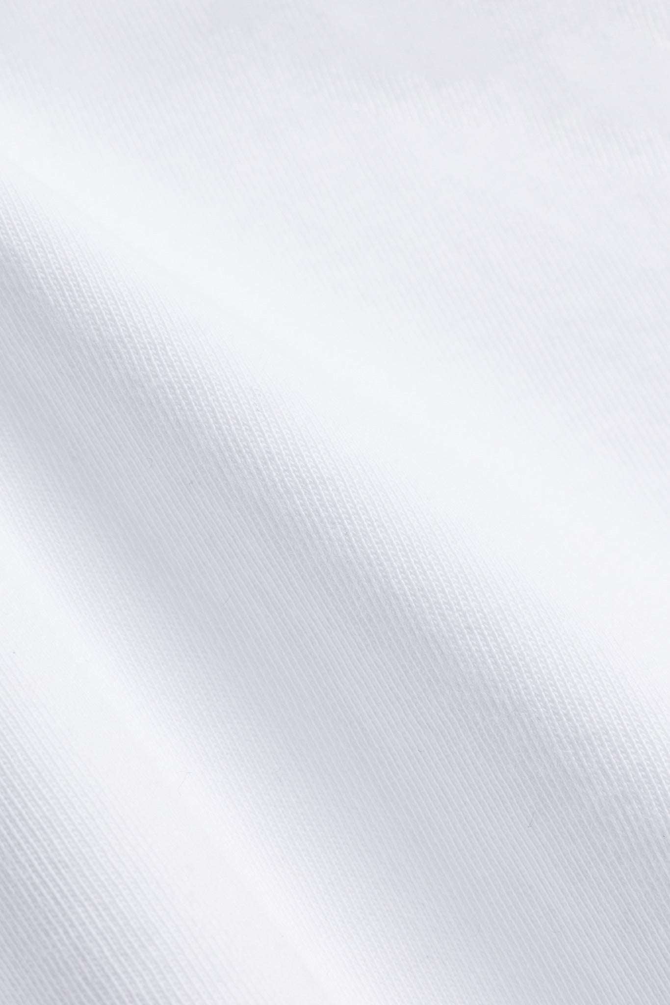 Close-up of the white pure cotton fabric texture on the CASPARA All-Star Signature Tee.